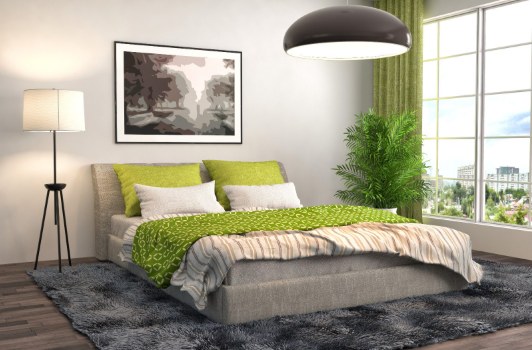 Schlafzimmer mit Bettwäsche und Vorhängen in Grüntönen